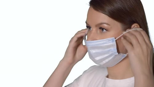 Young Caucasian Beautiful Woman Put on Protective Face Mask