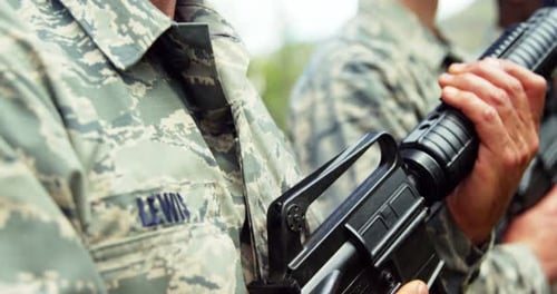 Soldiers Standing in Formation Holding Rifles