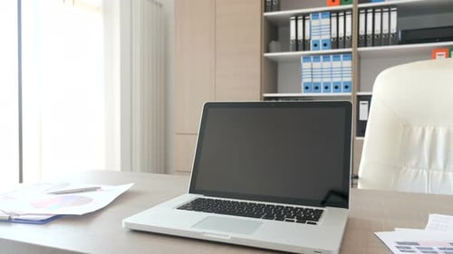 Laptop Screen To the Camera on a Desk in Empty Office