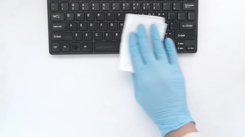 Hand Cleaning Keyboard with a Wipe, Overhead Shot