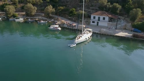 Aerial view of sailboat anchored on pier at mediterranean sea, Greece.