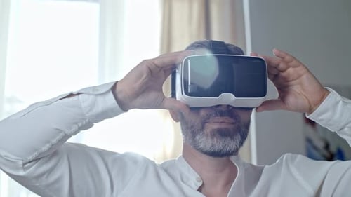 Man Using Virtual Reality Headset Indoors
