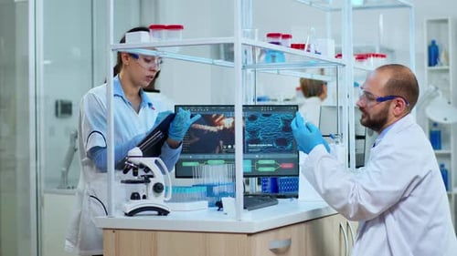 Scientists Collaborating on Research in a Bright Laboratory