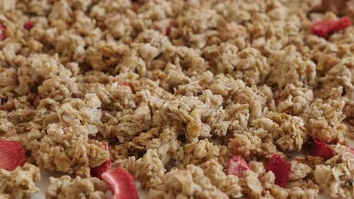 Tilting over muesli with strawberry flavour close-up 4K 2160p 30fps UltraHD footage - Healthy dehyd