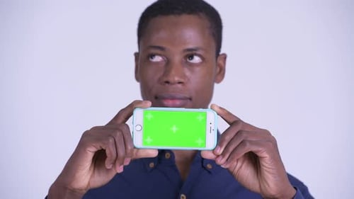 Adult Holds Phone with Green Screen Display