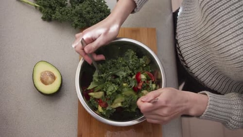 Mixing Fresh Vegetable Salad at Home