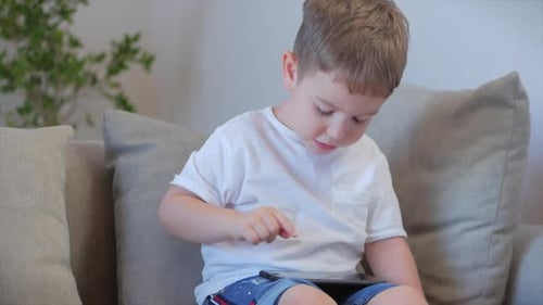 Young Child Interacting with Tablet at Home