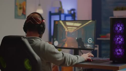 Young Adult Male Playing Video Game on Computer