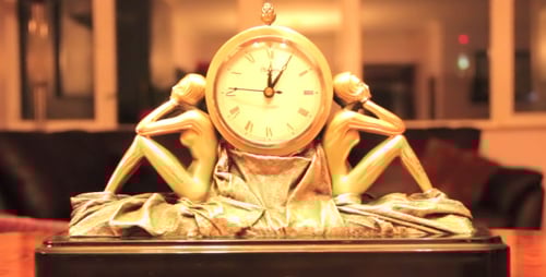 Elegant Golden Clock with Female Statues on Table