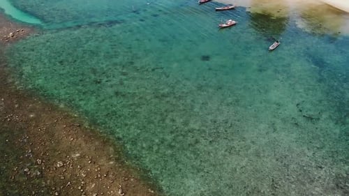 Fishing Boats Near Reef. Beautiful Aerial View of Fishing Boats Floating on Blue Sea Water Near