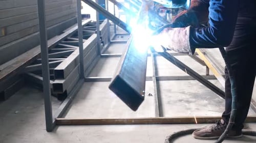 Metal Worker Welding Steel Framework in Workshop