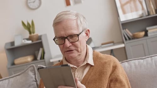 Close-Up of Elderly Man with Digital Tablet