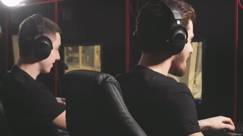 Young Adults Play Video Games Together in Dark Room