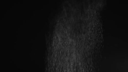 Shimmering Particle Cascade on Black Background