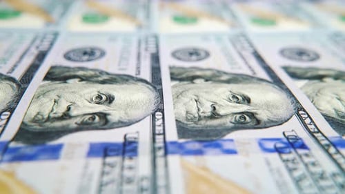 One Hundred Dollar Bills Lying in Row Macro Dolly Shot