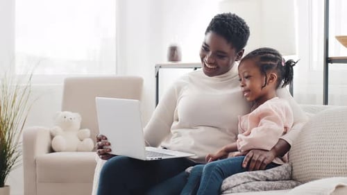 Mother and Child Looking at Laptop Together