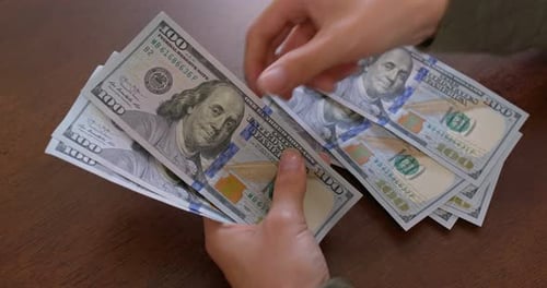 Person Counting Cash Money One Hundred Dollar Bills