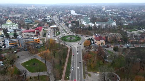 Aerial View of Roundabout Road with Circular Cars in Small European City at Cloudy Autumn Day