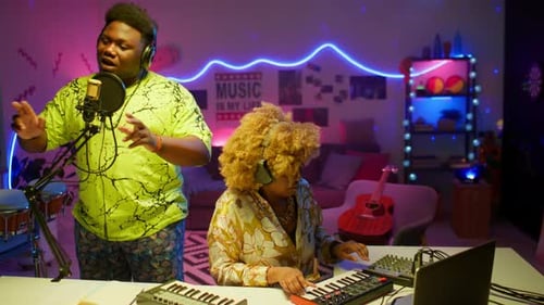 Black Singer Recording Song with Female Sound Engineer