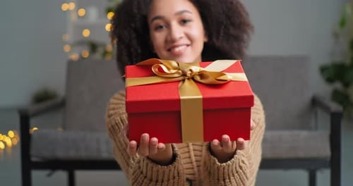 Young Adult Woman Holding a Christmas Gift