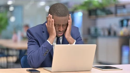 Loss, African Businessman Reacting To Failure on Laptop in Office