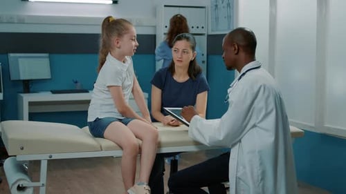 Doctor Discussing Results with Child and Mother