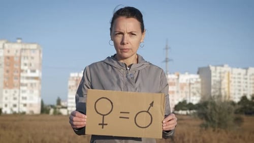 Woman Holds Gender Equality Sign Outdoors