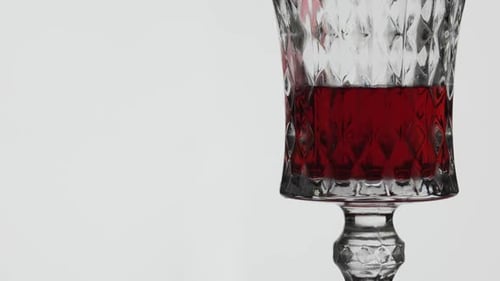 Red Liquid Pouring into Decorative Glass