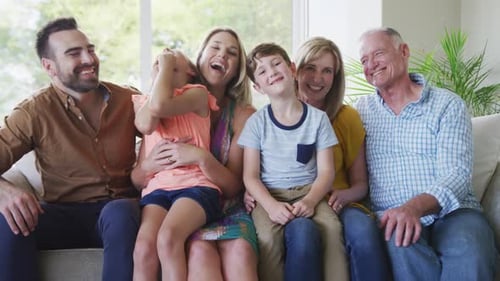 Happy Family Posing Together on a Sofa