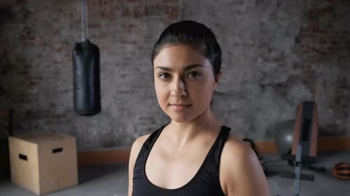 Woman Standing Still in Athletic Wear in Gym