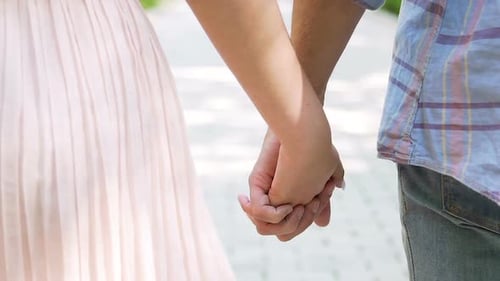 Romantic Couple on Date Walking with Hands Interlocked, Mutual Trust, Close-Up