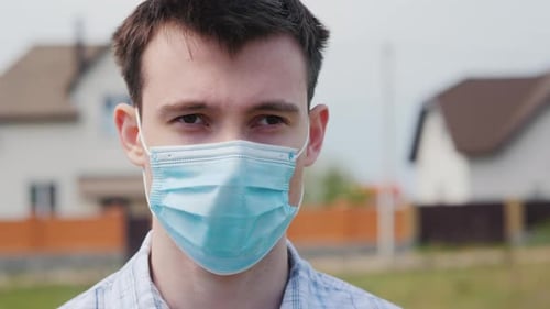 Young Adult Wearing a Face Mask Outdoors