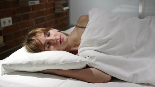 Blonde Woman Sleeping Soundly in Bed