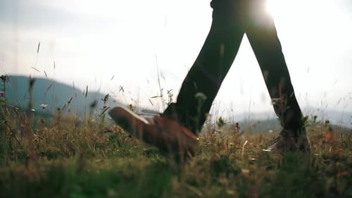 Man Groom or Bussinessman Legs Feet Steep Terrain on Field in Rays of Sun, Making Steps, Hiking