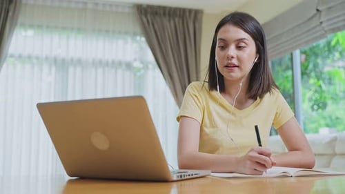 Distance learning of Asian Beautiful school girl study virtual online, watching video at home.