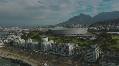 Aerial Ascending Footage of Modern Football Arena in City