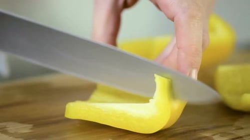 Slicing Yellow Bell Pepper on Cutting Board