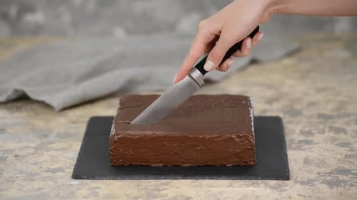 Cutting a Rich Chocolate Frosted Cake