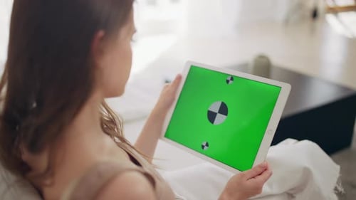 Girl Using Tablet with Green Chroma Key Background