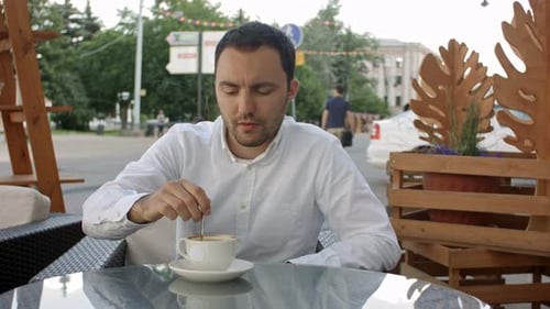 Businessman Having a Cappuccino at the Bar