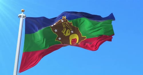 Blue Green Red Striped Flag with Central Gold Emblem Waving