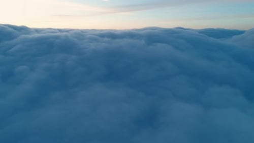 Aerial Flight over Clouds at Sunrise or Sunset