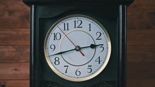 Vintage Wall Clock with Moving Second Hand on Wooden Background