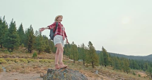 Hipster Millennial Young Woman in Red Plaid Shirt Staying on Hill on Cloudy Day