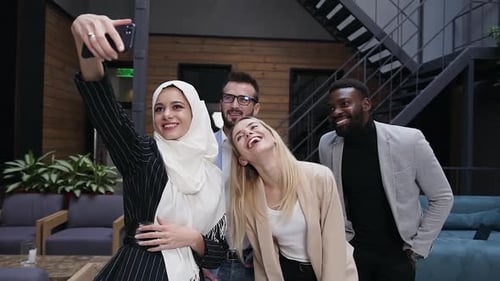 Multiracial Business Team Making Funny Selfie in the Modern Office Interier