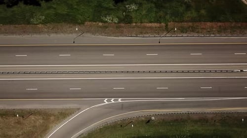 Top Down Flyover View of Highway Intersection Car Bridge and Moving Cars