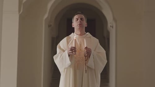 Clergyman Praying With Candle and Rosary