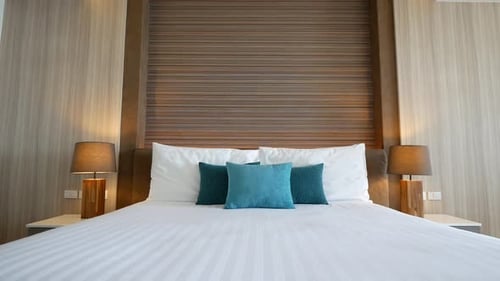 Modern Bedroom Interior with Pillows and Lamps