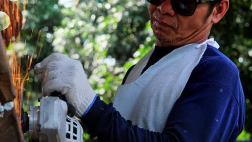 Man Grinding Metal with an Angle Grinder Tool