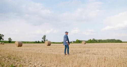 Farmer with Tablet Computer Analyzing Crops at Farm